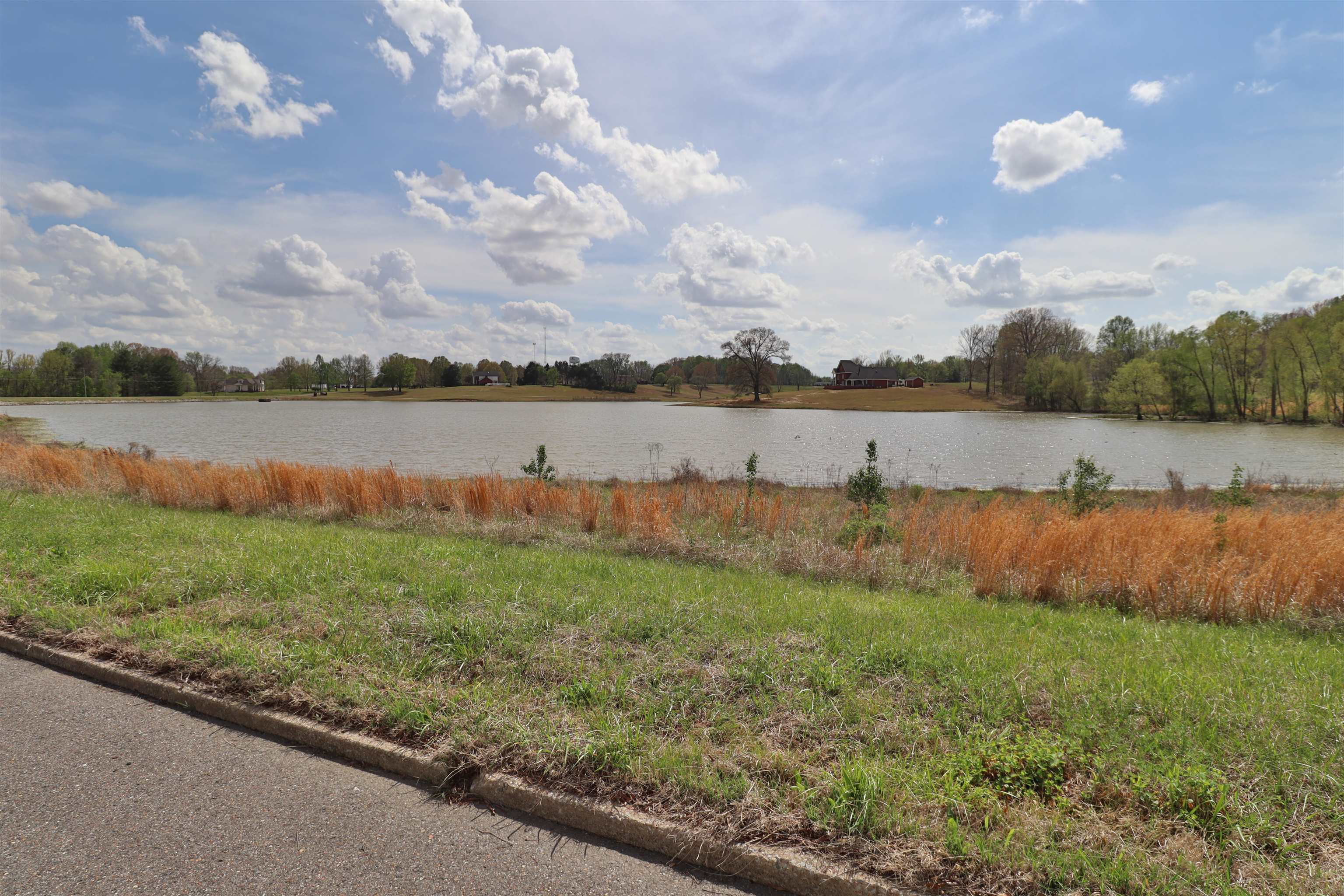 0 Hunters Trace Drive Ripley, TN 38063 - Photo 18 of 33 a view of a lake with houses in the back
