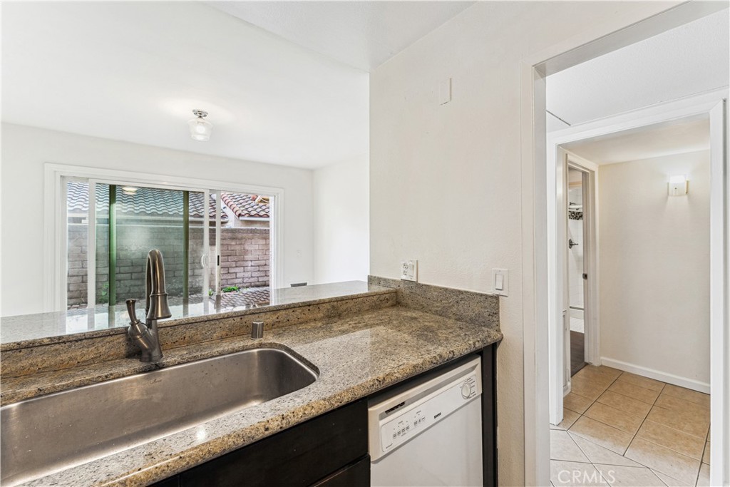 999 West Pine Street, Unit D Upland, CA 91786 - Photo 2 of 16 a kitchen with granite countertop a sink and a window