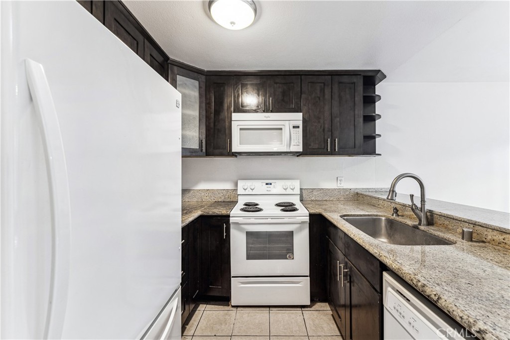 999 West Pine Street, Unit D Upland, CA 91786 - Photo 7 of 16 a kitchen with a sink stove and microwave