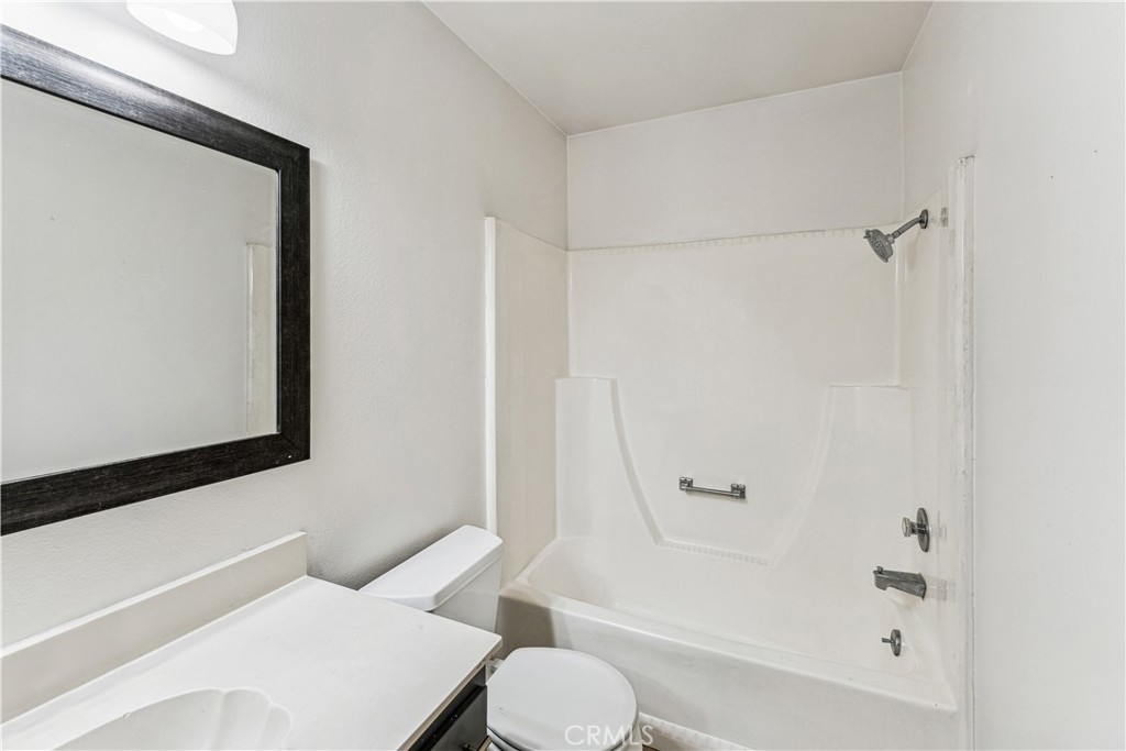 999 West Pine Street, Unit D Upland, CA 91786 - Photo 9 of 16 a bathroom with a toilet and a shower