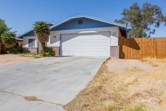 600 Beth Lane Ridgecrest, CA 93555 - Photo 5 of 25 a front view of a house with a yard and garage