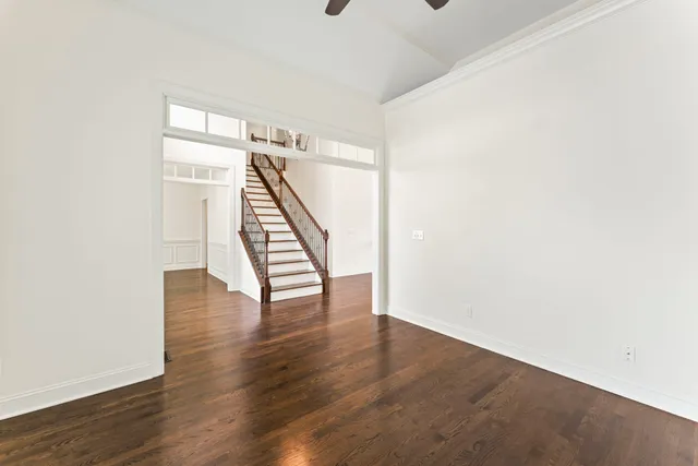 a view of a room with wooden floor and a window