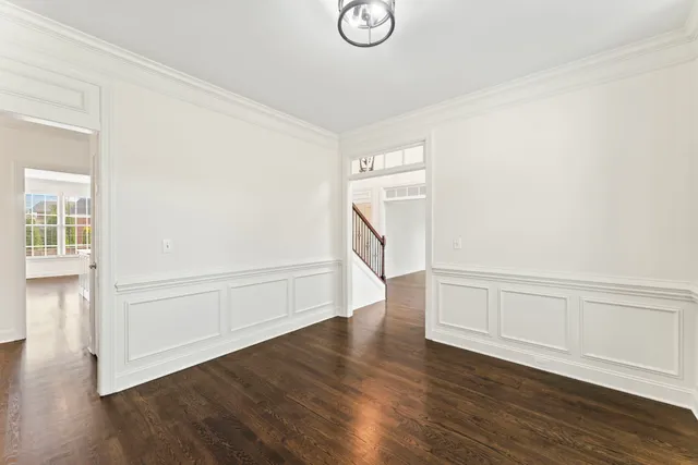 a bathroom with a granite countertop sink toilet a mirror and a window