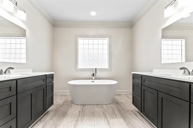 a spacious bathroom with a shower sink and mirror