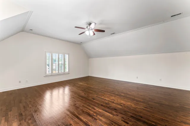 a front view of a house with yard and green space