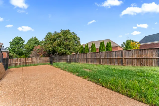 a view of a backyard with a garden and deck