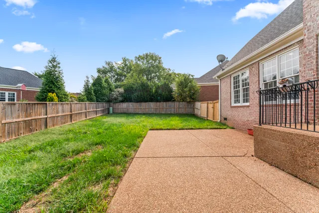 a view of a house with a yard and sitting area