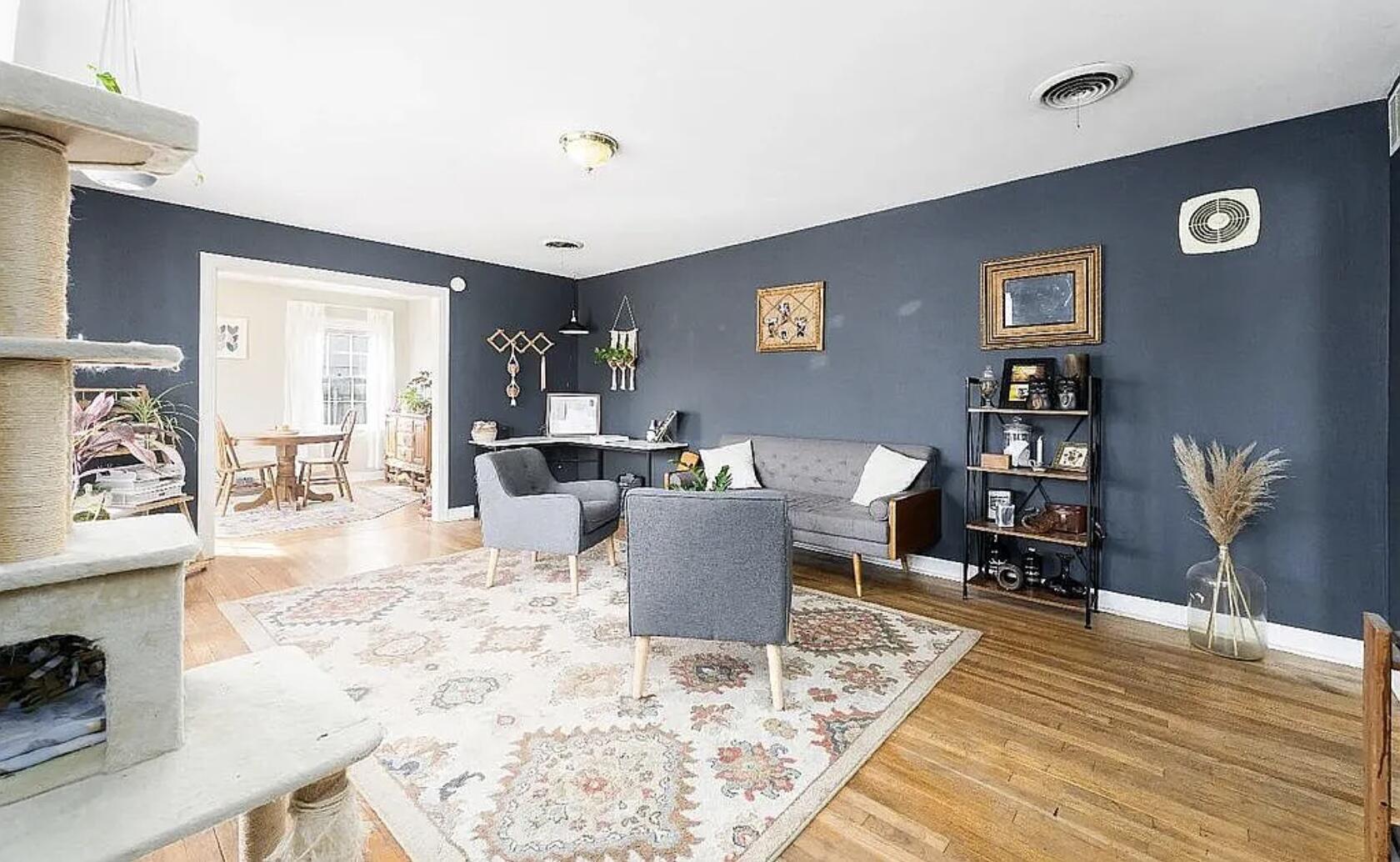 a living room with furniture and wooden floor