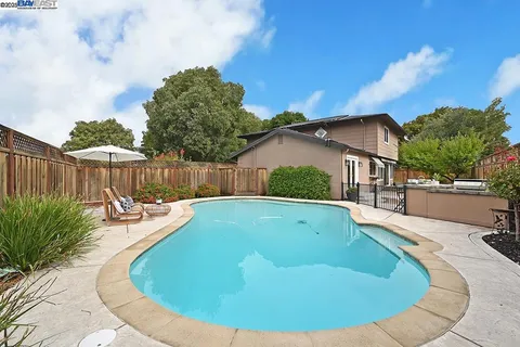 a view of a swimming pool with a lounge chair