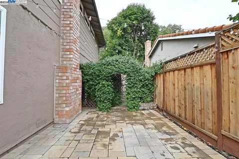 a view of a pathway of a house with potted plants