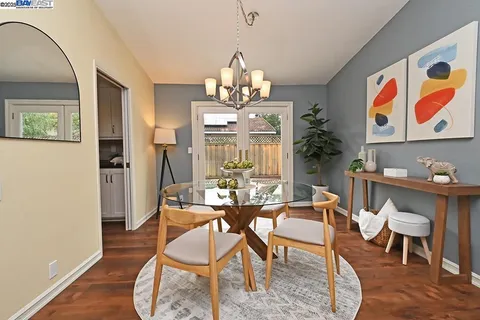 a dining room with furniture a rug and wooden floor