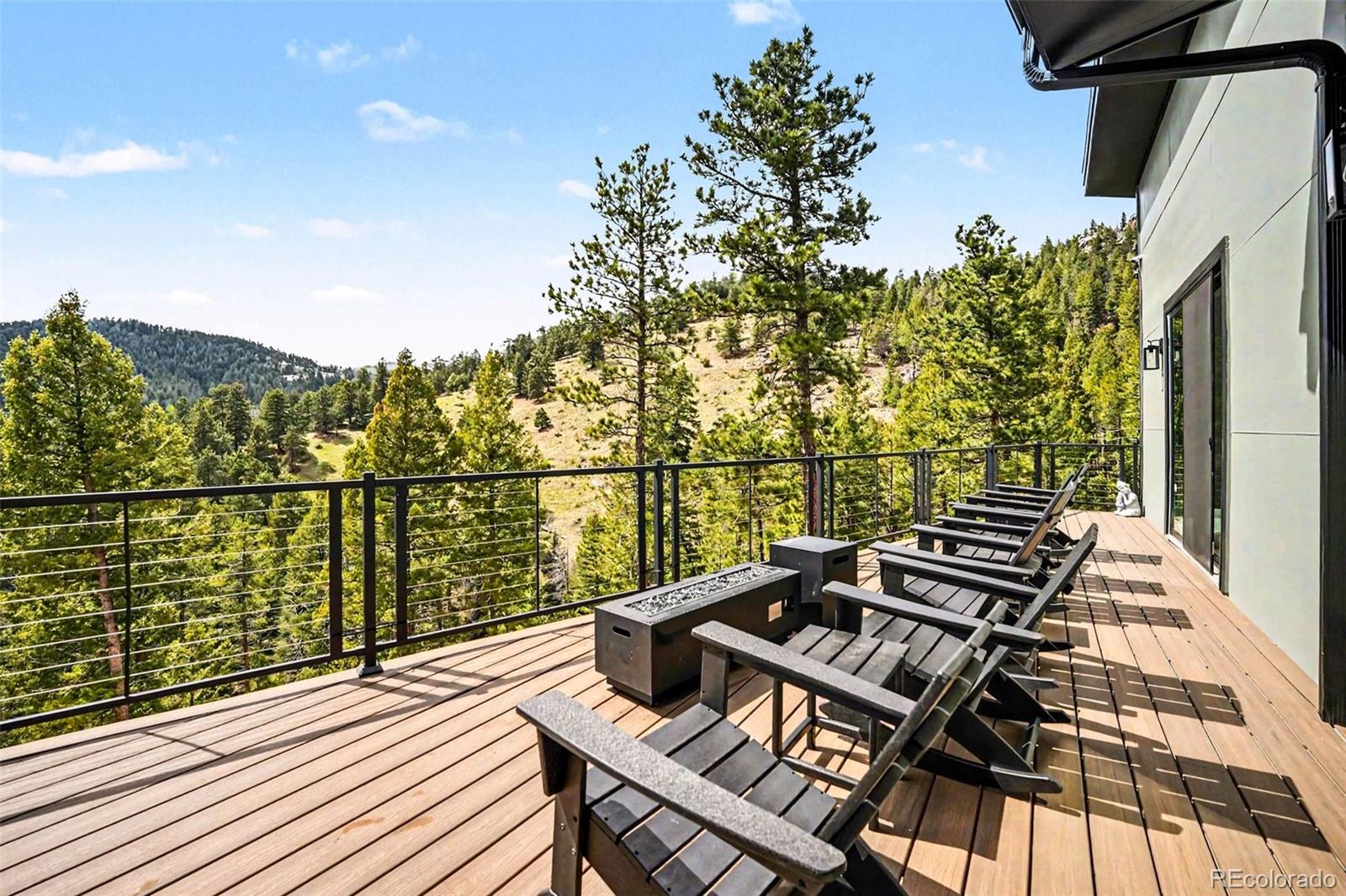 7231 Timber Trail Road Evergreen, CO 80439 - Photo 29 of 35 a view of a balcony with wooden floor and iron stairs