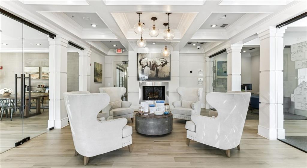 2910 Clairmont Road, Unit PLAN 1 Atlanta, GA 30329 - Photo 11 of 29 a living room with fireplace furniture and a chandelier