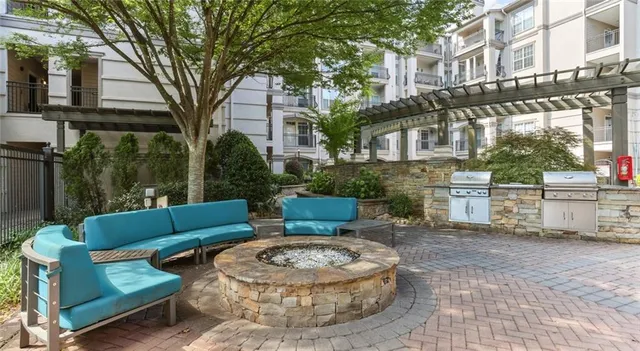a view of a patio with couches and a fire pit