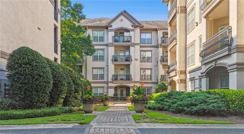 2910 Clairmont Road, Unit PLAN 1 Atlanta, GA 30329 - Photo 5 of 29 a view of a brick building next to a yard