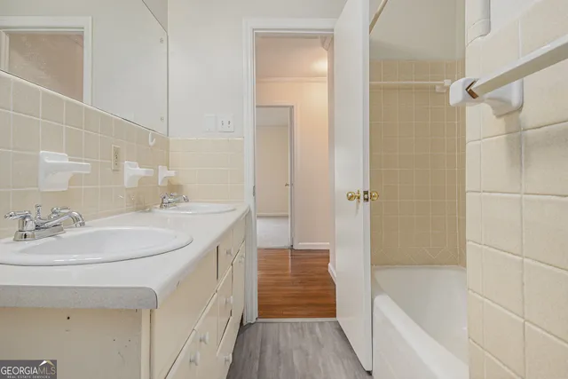 a bathroom with a bathtub a sink a vanity and a shower