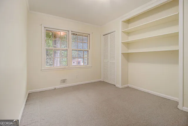 a view of an empty room with a window