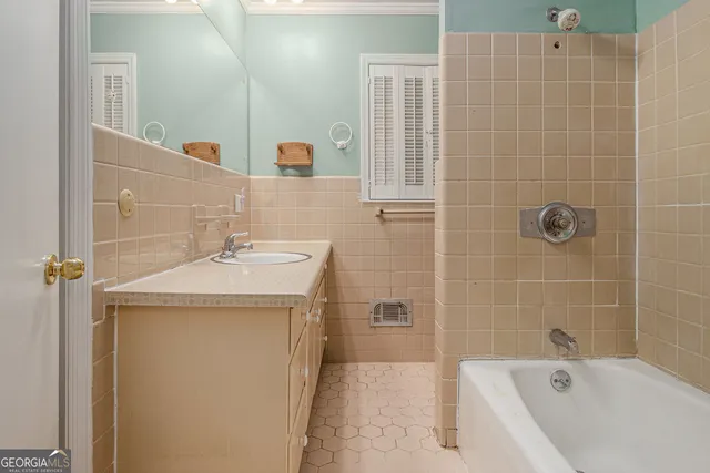 a bathroom with a sink a mirror and a bathtub
