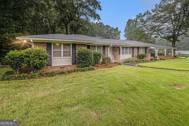 a front view of house with yard and green space