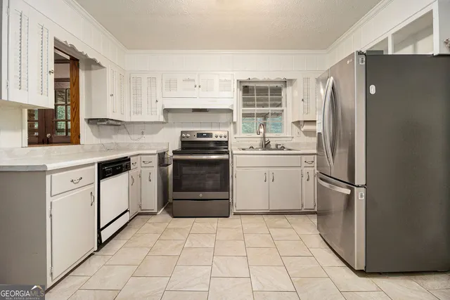 a kitchen with a stove a refrigerator and a sink