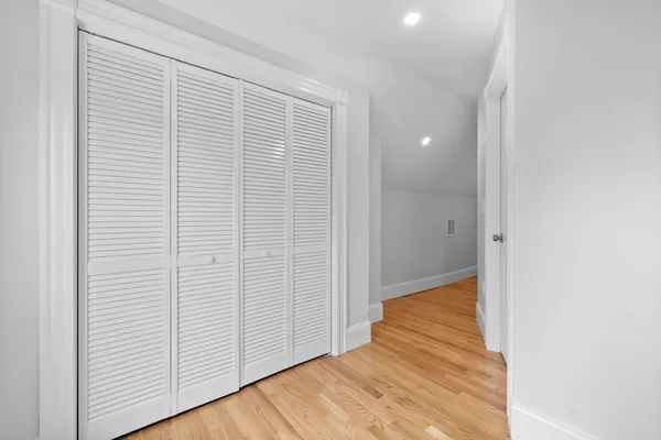 a view of a room with wooden floor