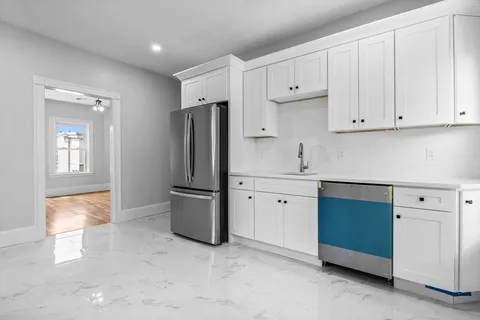 a kitchen with stainless steel appliances granite countertop a refrigerator sink and cabinets