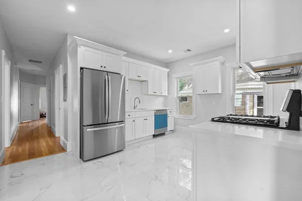 a kitchen with stainless steel appliances a refrigerator and a stove
