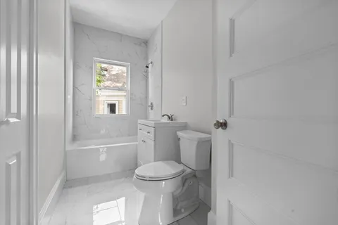 a bathroom with a toilet and a bath tub