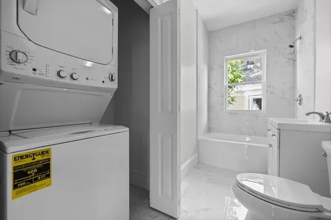 a bathroom with a sink a toilet and tub