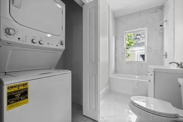 a bathroom with a sink a toilet and tub