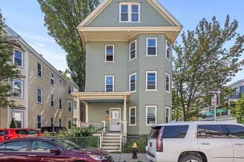 a front view of a residential houses with yard