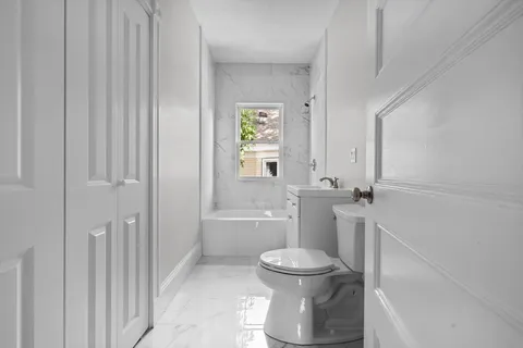 a bathroom with a toilet and a bathtub