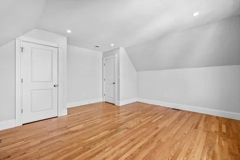 a view of an empty room and wooden floor