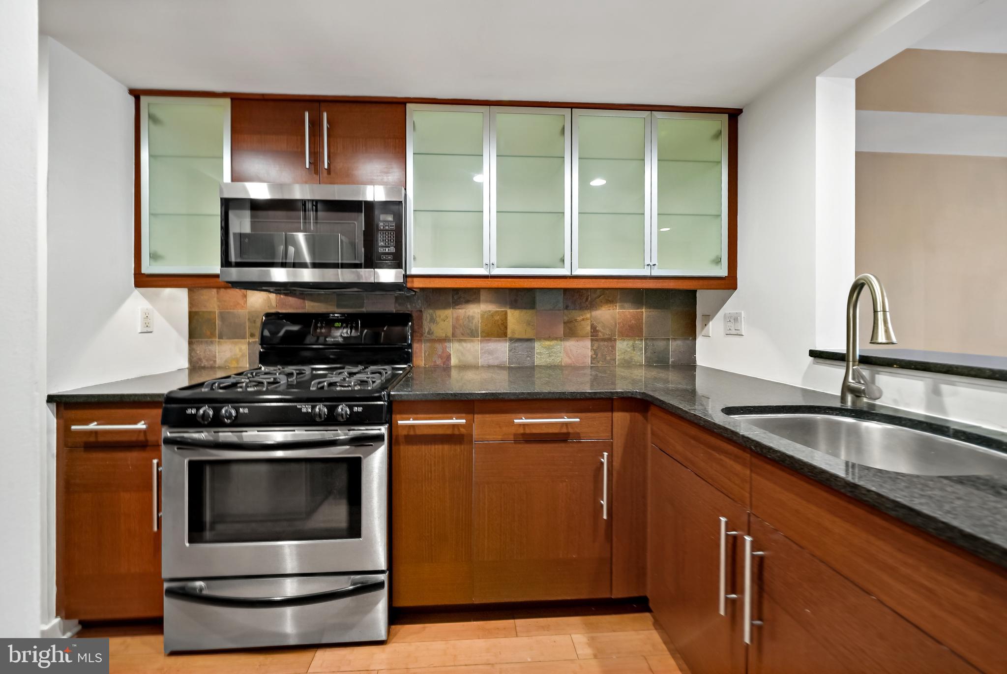 4041 Cresson Street Philadelphia, PA 19127 - Photo 11 of 32 a kitchen with granite countertop a stove and a sink