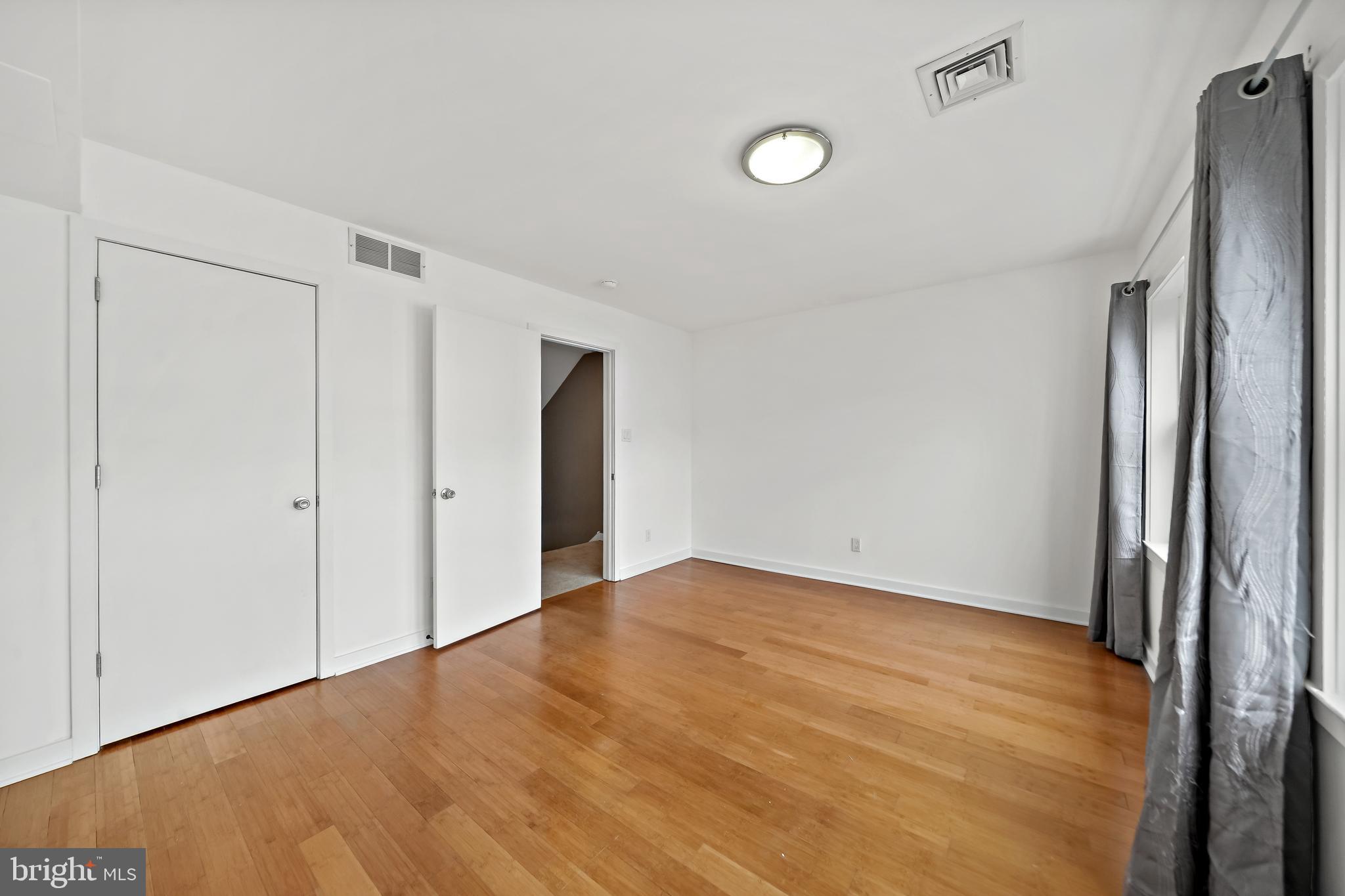 4041 Cresson Street Philadelphia, PA 19127 - Photo 15 of 32 a view of an empty room with wooden floor and a window