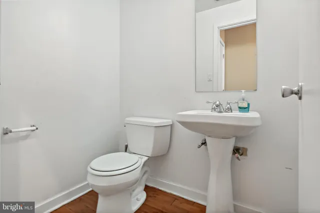 a bathroom with a sink toilet and a mirror