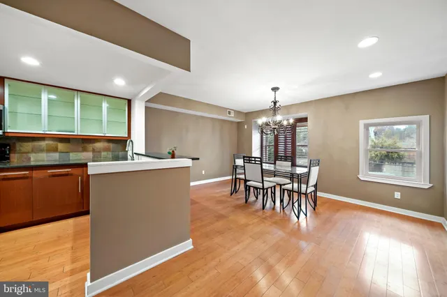 a kitchen with kitchen island dining table and stainless steel appliances
