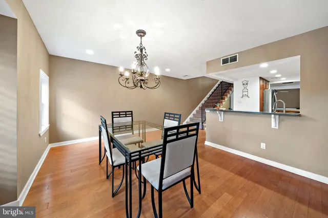 a view of a dining room with furniture and chandelier