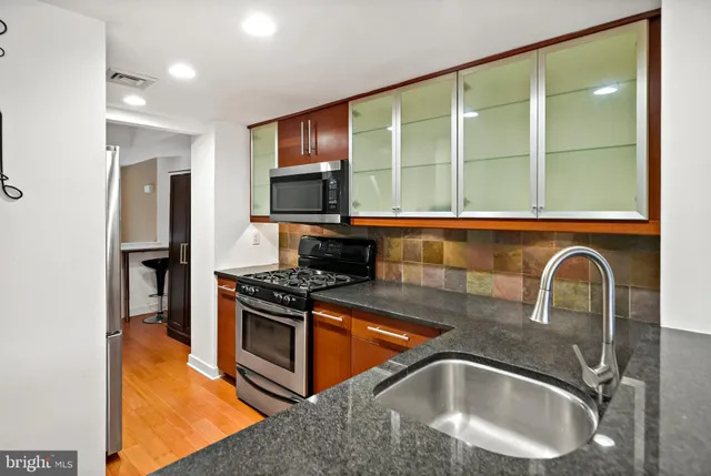 a kitchen with a stove a sink and a microwave