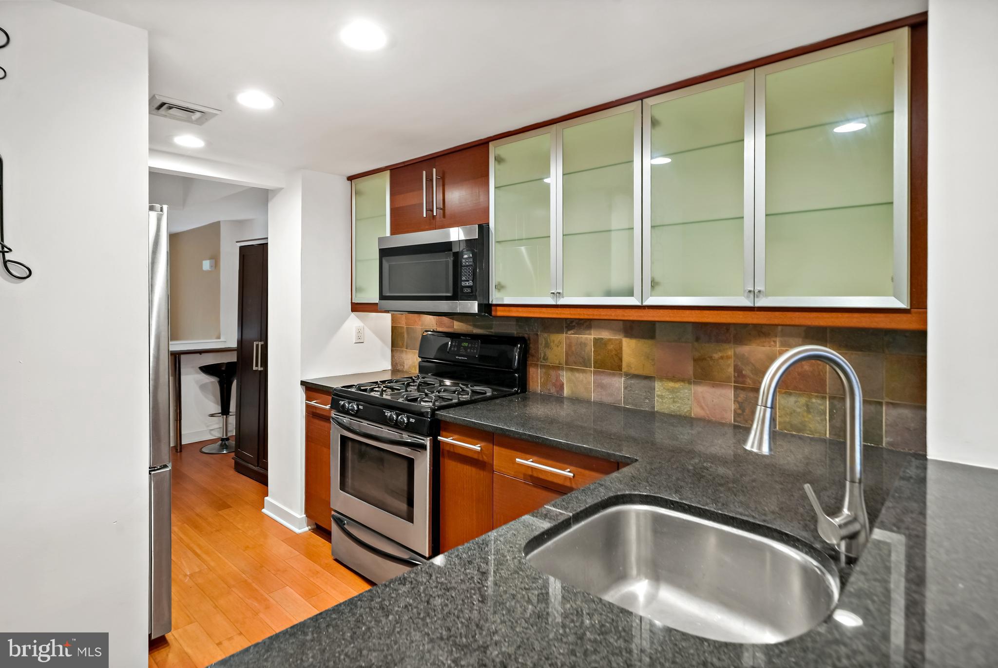 4041 Cresson Street Philadelphia, PA 19127 - Photo 9 of 32 a kitchen with a stove a sink and a microwave