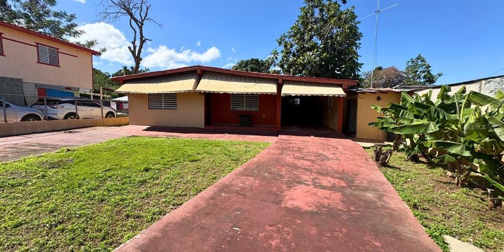 489 20th Street Cabo Rojo, PR 00623 - Photo 1 of 1 a front view of a house with a yard and garage