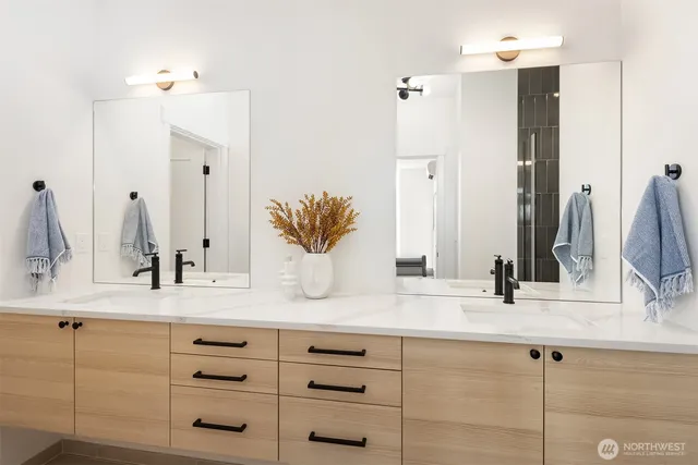 a bathroom with a double vanity sink and a mirror