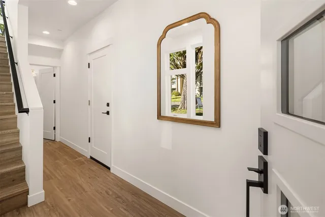 a view of an entryway with wooden floor