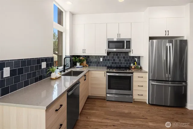a kitchen with a sink stove and refrigerator