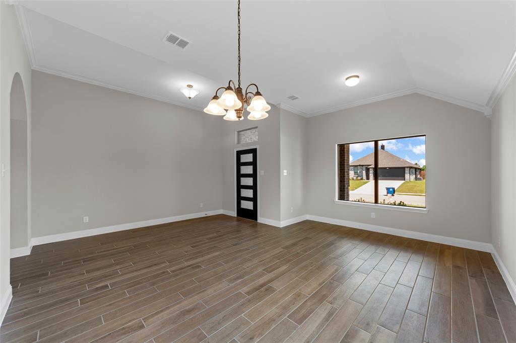 314 Pennington Road Josephine, TX 75173 - Photo 7 of 26 a view of an empty room with wooden floor and a window