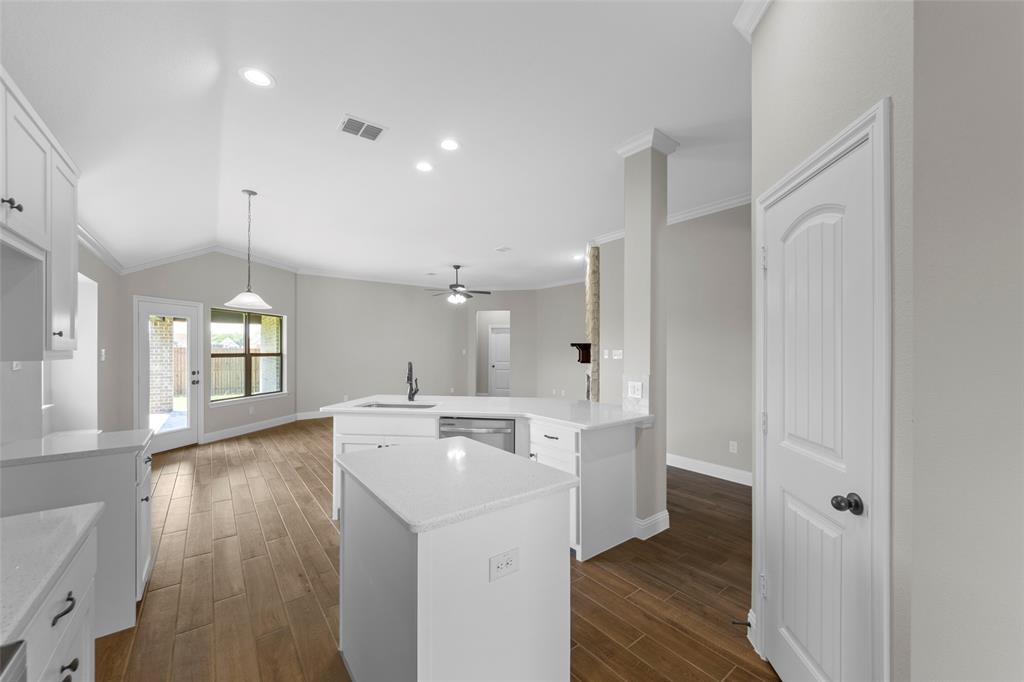 314 Pennington Road Josephine, TX 75173 - Photo 8 of 26 a view of a kitchen with a sink wooden floor and windows
