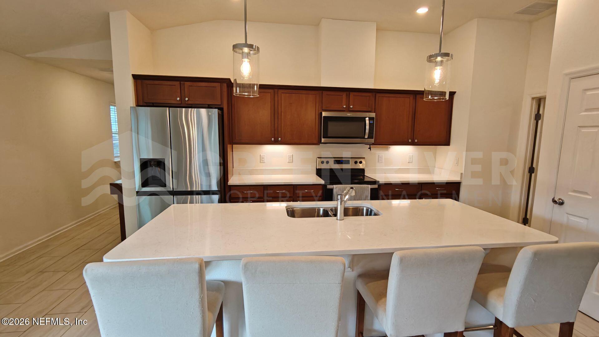 352 Rambling Brk Trail St. Johns, FL 32259 - Photo 12 of 35 a kitchen with kitchen island a sink appliances and cabinets