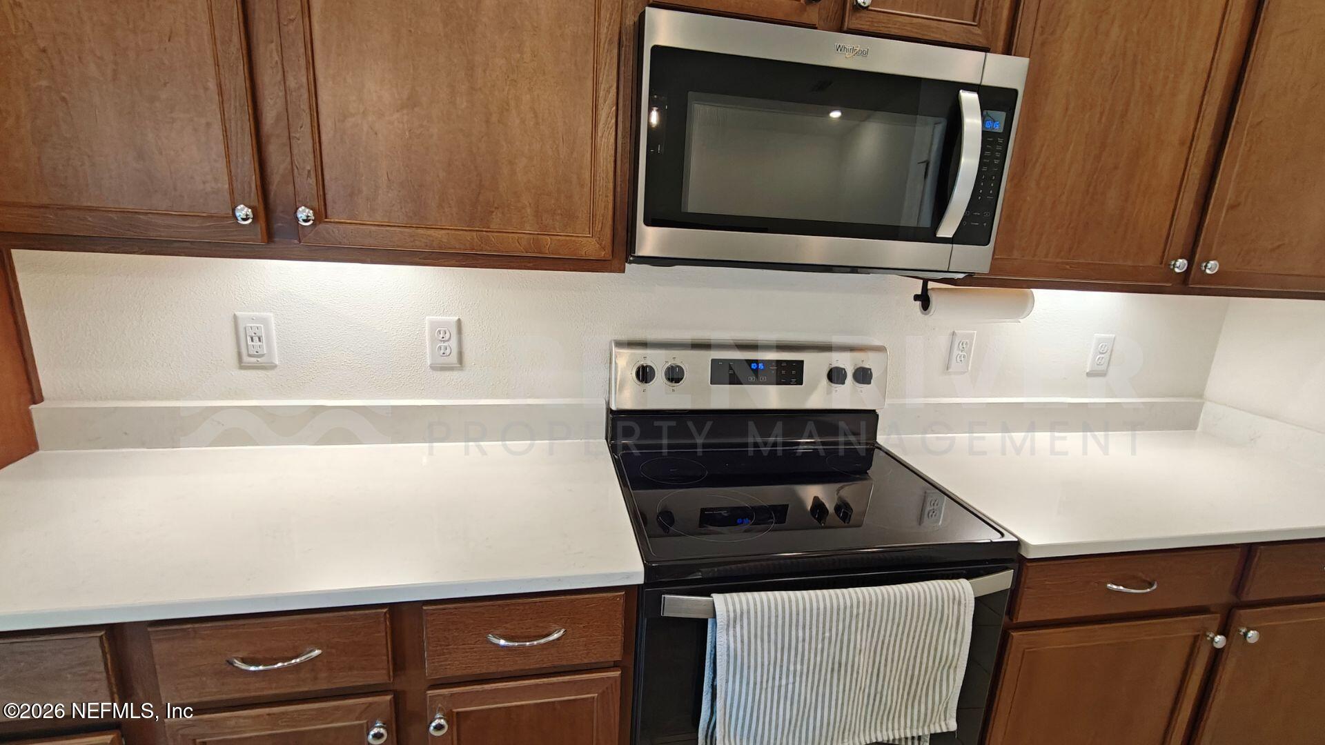 352 Rambling Brk Trail St. Johns, FL 32259 - Photo 16 of 35 a kitchen with a stove and a microwave