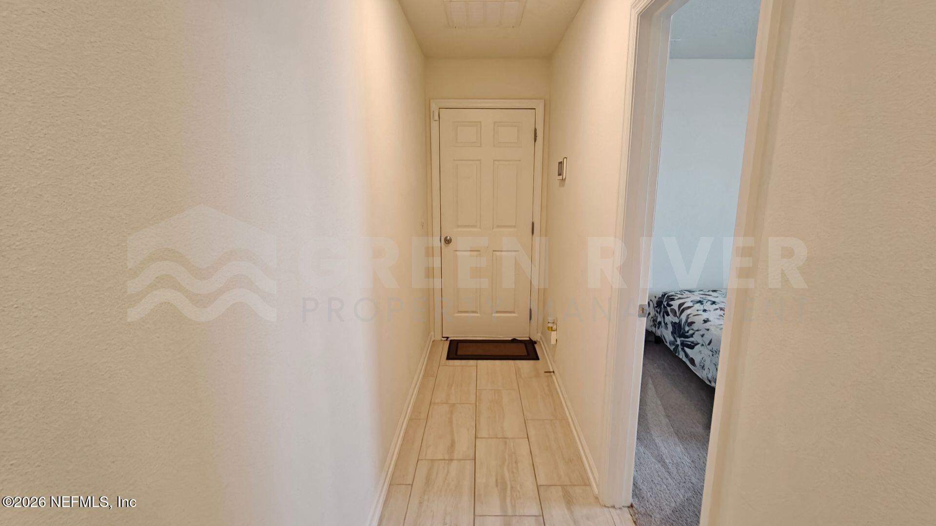 352 Rambling Brk Trail St. Johns, FL 32259 - Photo 23 of 35 a view of a hallway with wooden floor and a bathroom