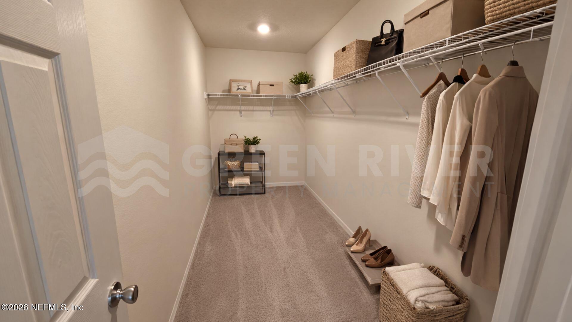 352 Rambling Brk Trail St. Johns, FL 32259 - Photo 28 of 35 a view of walk in closet with clothes and shoes